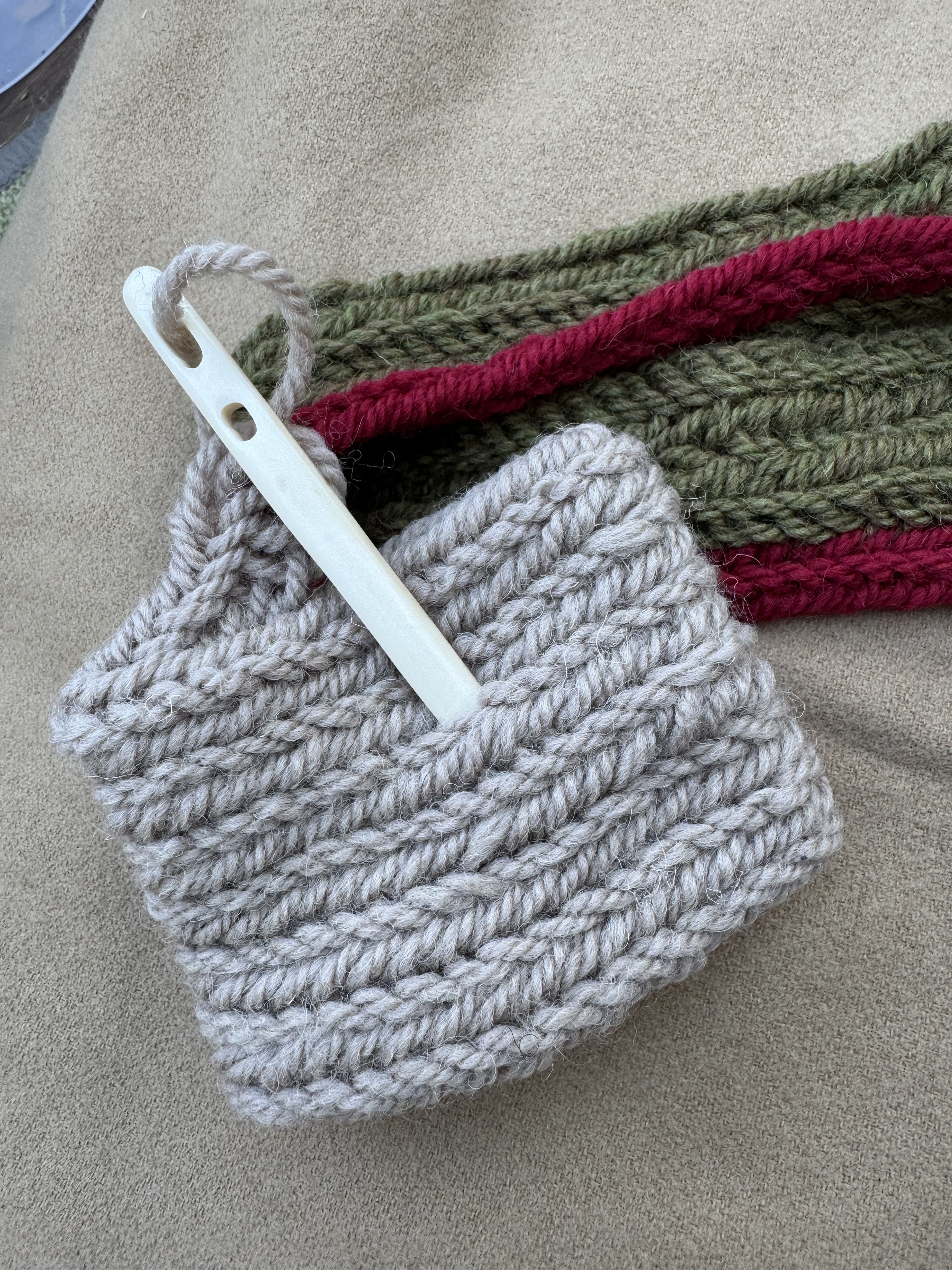 Crochet hooks and colourful yarn on a wooden table