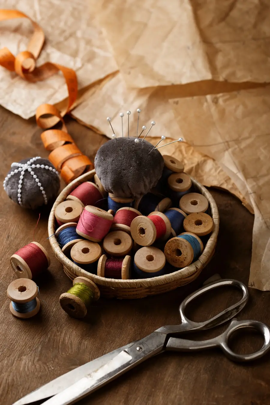 Traditional tailoring tools with thread, scissors and pattern paper